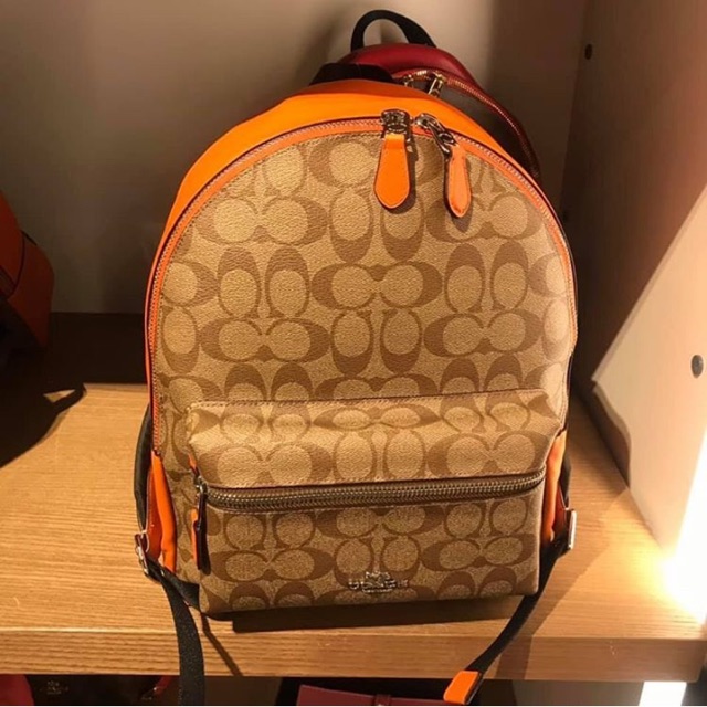 Orange best sale coach backpack